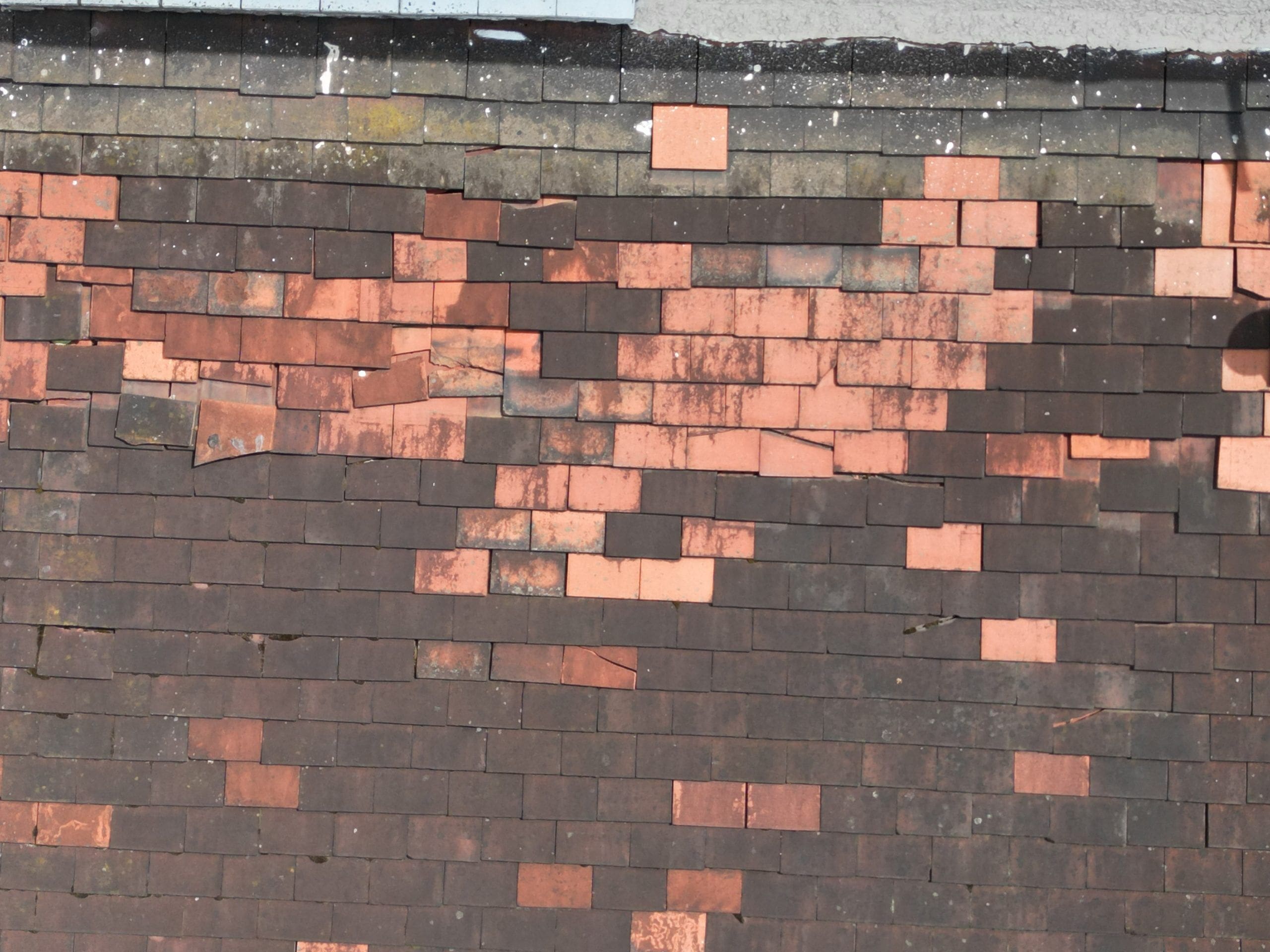 Roof survey image of a semi detached house with defective tiles.