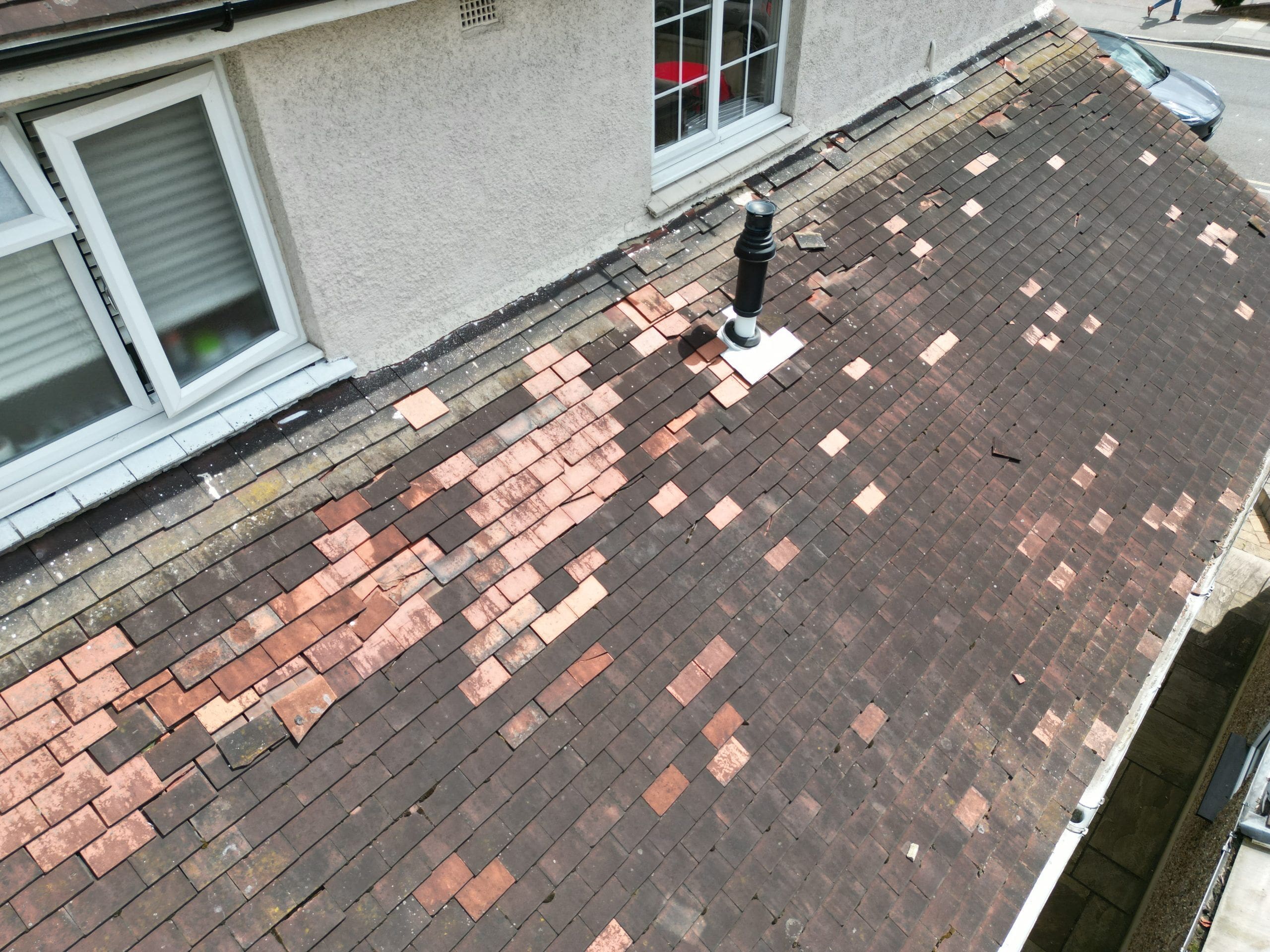 Roof survey image of a semi detached house with defective tiles.