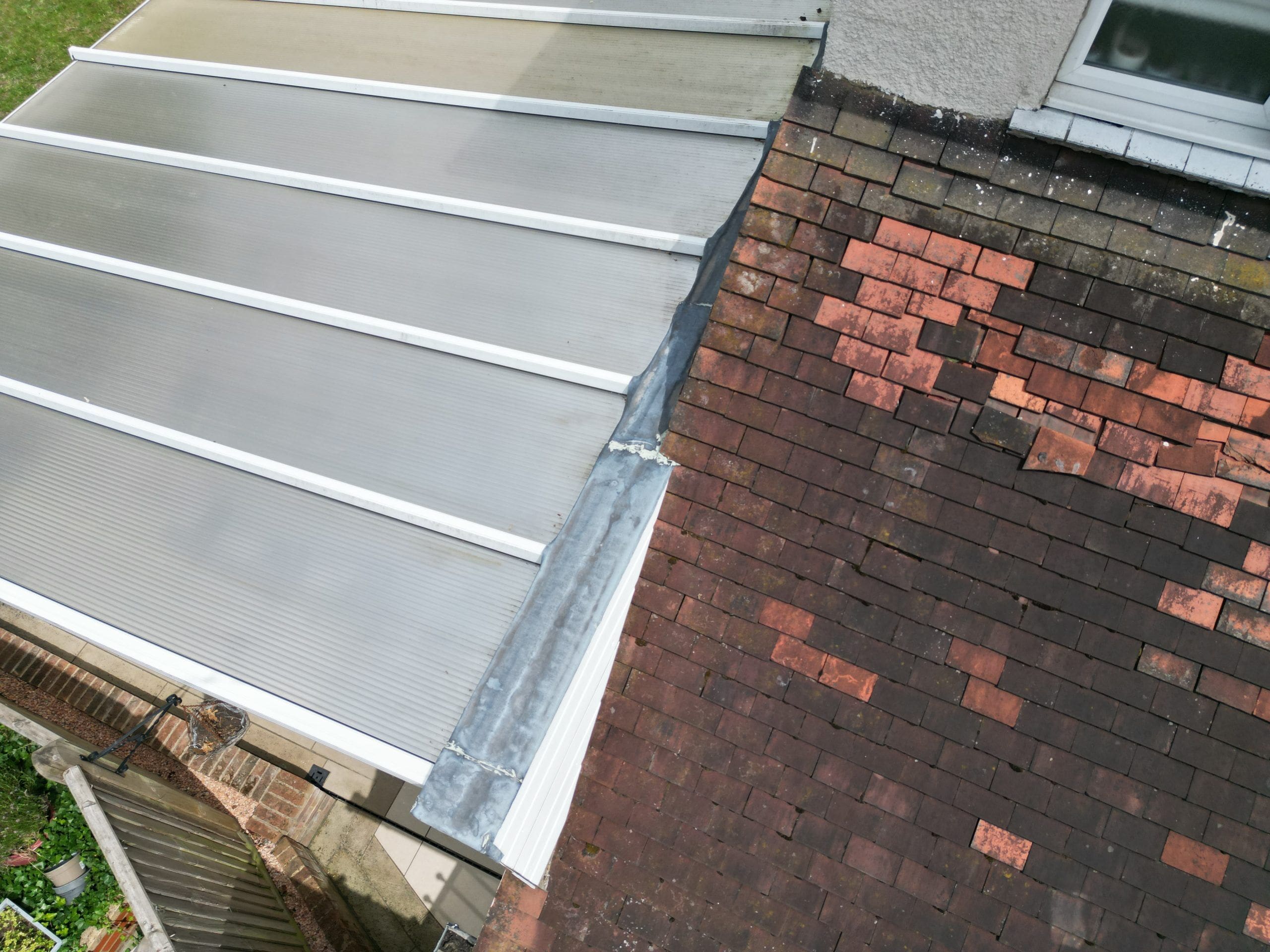 Roof survey image of a semi detached house with defective tiles.